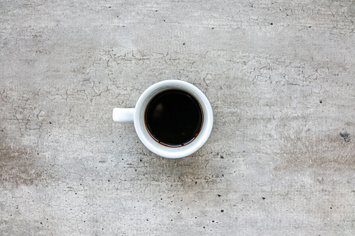 Coffe espresso cup on concrete background from above