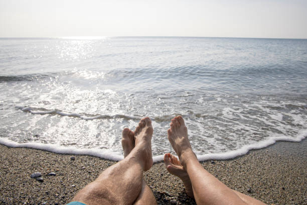 istock Couple enjoy seaside moments on coastal beach 1437650816