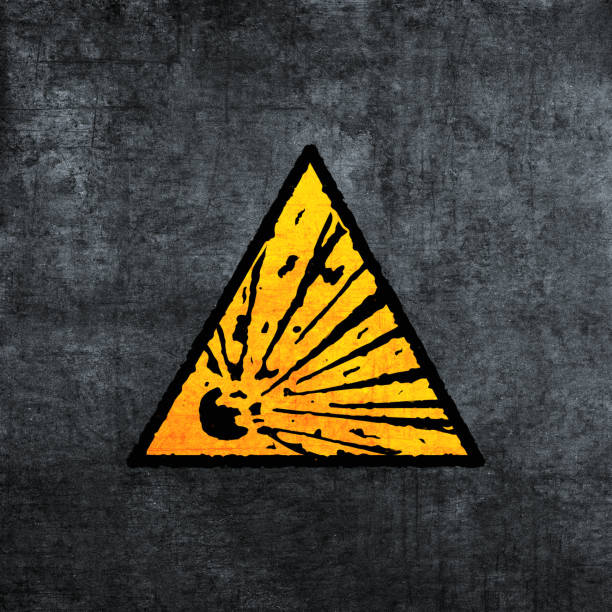 Explosive warning sign, yellow on gray. Risk of explosion icon (triangle). Grunge texture effect. Yellow on gray