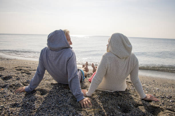 istock Couple enjoy seaside moments on coastal beach 1437651057