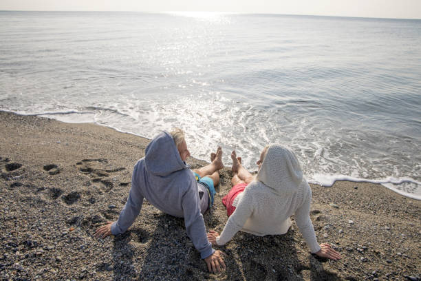 istock Couple enjoy seaside moments on coastal beach 1437651842