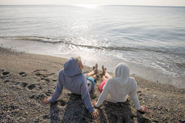 istock Couple enjoy seaside moments on coastal beach 1437651905