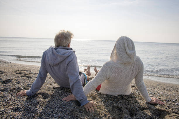 istock Couple enjoy seaside moments on coastal beach 1437651908