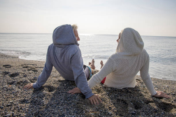 istock Couple enjoy seaside moments on coastal beach 1437652152