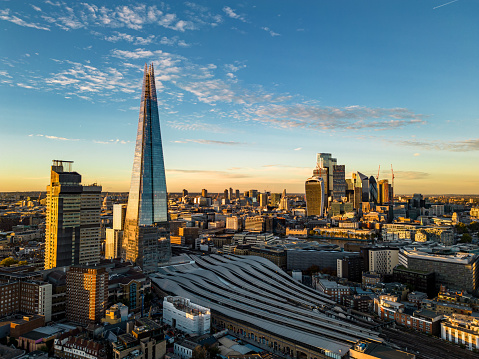 Sunset aerial view of London cityscape including the iconic Shard building.