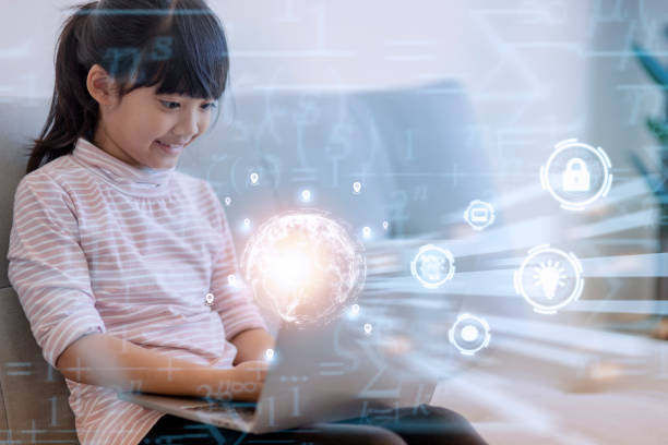 Asian little girl using the laptop. Internet of Things. EdTech.