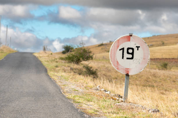 istock Desolate road in the countryside on a sunny summer day. 1437653400