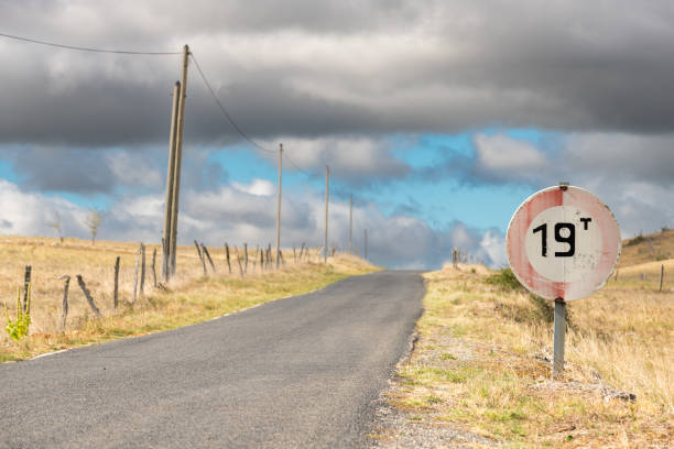 istock Desolate road in the countryside on a sunny summer day. 1437653403