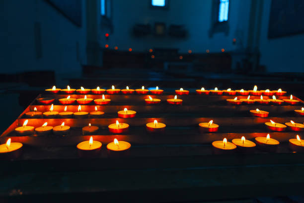 Candles in Catholic church . Candlelight in the dark room