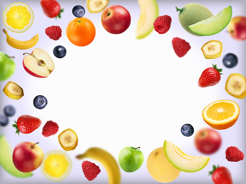 Overhead view of a composition of healthy fruits and a yellow tape measure shot on white background. The composition is at the bottom of an horizontal frame making a border and leaving copy space.  High resolution 42Mp studio digital capture taken with SONY A7rII and Zeiss Batis 40mm F2.0 CF lens