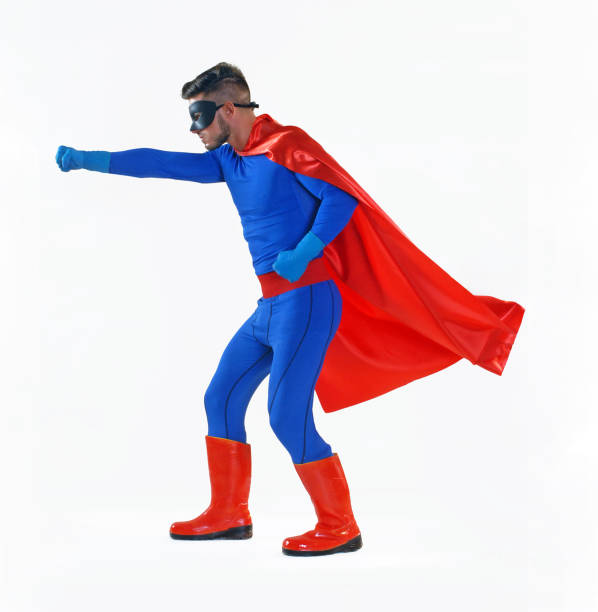 man with blue cape and red mask posing like a superhero, using LED lights.