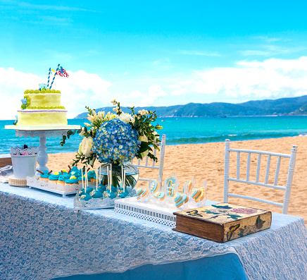 Beautiful wedding cake  on the table. Table with the cake on the beach of tropics.