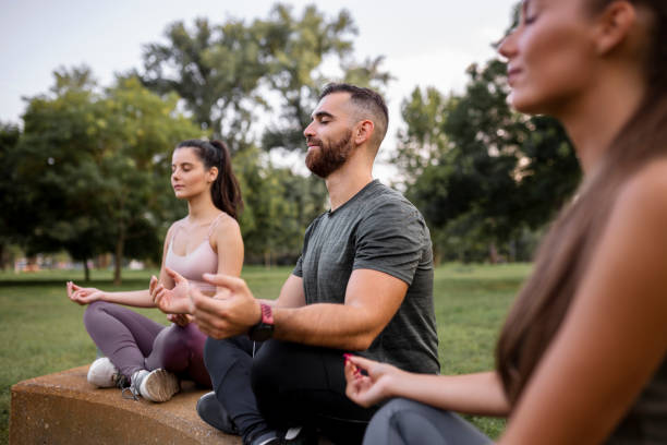 istock Three people meditating outdoors 1437656226