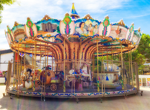 Outdoor vintage flying horse carousel in the the city