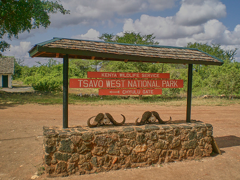 Entrance sign of Tsavo West national Park in Kenya with Buffalo skulls