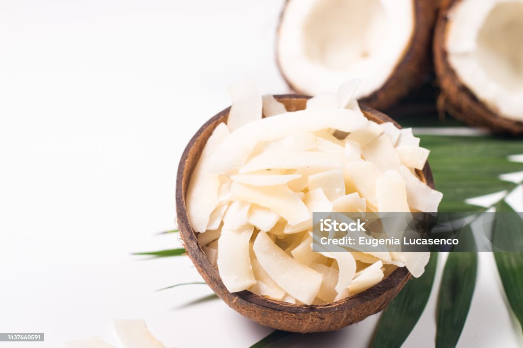 Coconut chips with coconut and green leaves Coconut Stock Photo Coconut chips with coconut and green leaves Coconut Stock Photo