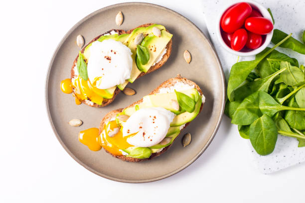 istock Toast with avocado, soft cream cheese, rye bread and poached Egg. Wholemeal open sandwich for healthy breakfast concept. 1437661181