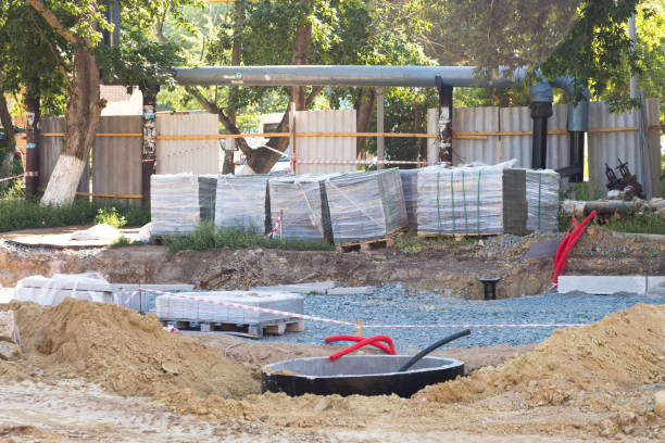 istock Construction site with a mountain of earth and a warehouse of materials 1437662027