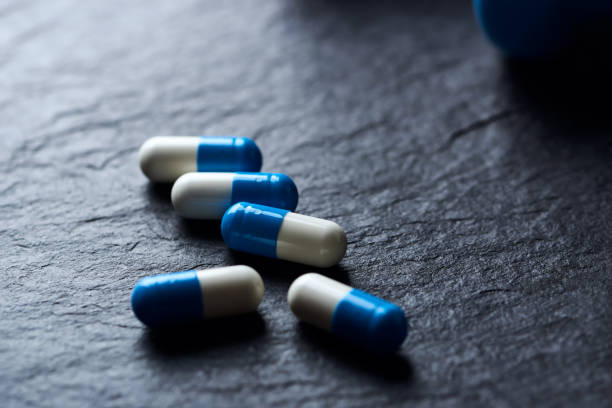 istock Sports Supplements (creatine capsules) on dark stone background. Close up. 1437662064
