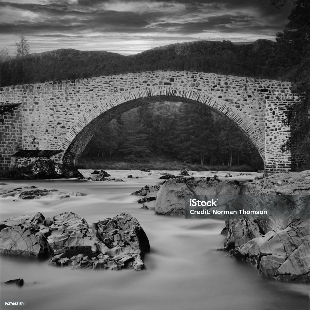 Invercauld, Braemar, Scotland - September 2022: The old bridge over the River Dee at Invercauld, Braemar. The old bridge over the River Dee on the Balmoral Estate in Scotland. The bridge is used for pedestrians only. Balmoral Castle Stock Photo