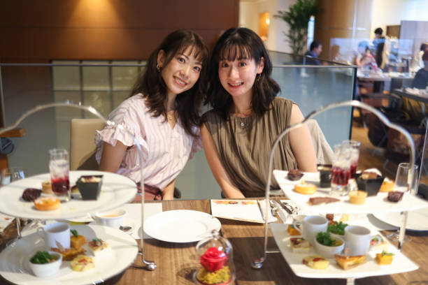 istock Beautiful young wmen enjoying afternoon tea 1437665154