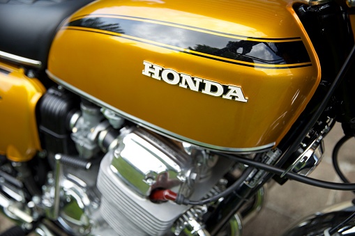 Honfleur, France – June 01, 2022: A closeup of a yellow vintage Honda CB750 bike detail