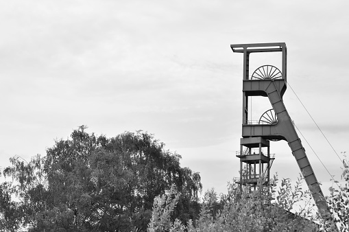 A grayscale shot of the winding tower of an old colliery in Essen, Ruhr area, NRW, Germany.