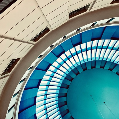 The low-angle partial view of a modern building blue ceiling - beautiful choice for backgrounds