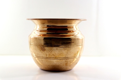 A closeup shot of the Indian shining copper bowl  on a white surface
