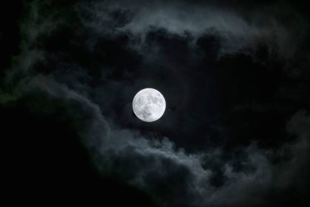 istock Mesmerizing view of a moon in the dark cloudy sky 1437670762