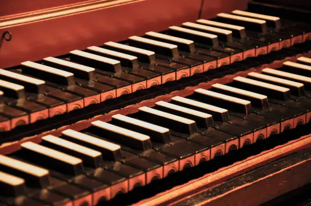 A closeup shot of a harpsichord the musical instrument played by means of a keyboard