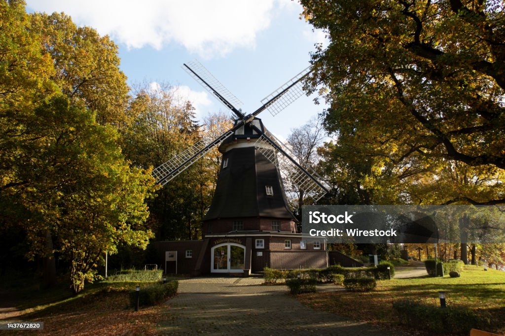 Old windmill surrounded by lush vegetation in Meppen, Emsland, Germany An old windmill surrounded by lush vegetation in Meppen, Emsland, Germany Meppen Stock Photo