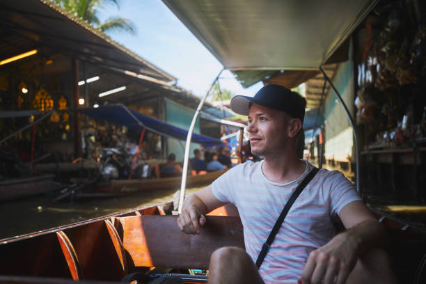 istock Tourist enjoys trip to floating market 1437673070
