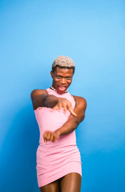 istock Black androgynous model in pink dress dancing 1437673745