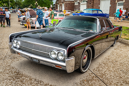 Des Moines, IA - July 01, 2022: High perspective front corner view of a 1963 Lincoln Continental 4 Door Sedan at a local car show.