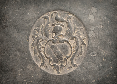 An engraved stone plaque on a tomb in the floor of St Nicholas’ Chapel in King’s Lynn, Norfolk, Eastern England. The current St Nicholas Chapel was built in the early 15th century as a ‘chapel of ease’ granted to the monks of the priory church of St Margaret (now King’s Lynn Minster).