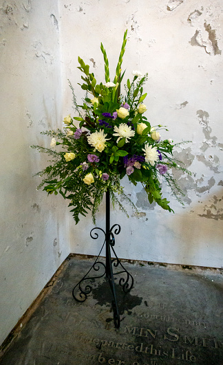 A display of flowers in a corner of the Minster church of St Margaret, King’s Lynn, in Norfolk, Eastern England. Queen Elizabeth II had recently died and the church was being prepared for a memorial service in her honour, with flowers in white and shades of purple.