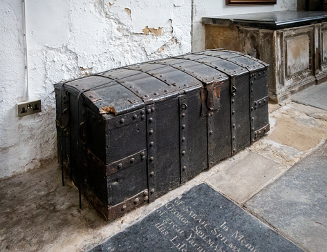 An old wooden parish chest inside St Nicholas’ Chapel in King’s Lynn, Norfolk, Eastern England. The current St Nicholas Chapel was built in the early 15th century as a ‘chapel of ease’ granted to the monks of the priory church of St Margaret (now King’s Lynn Minster).