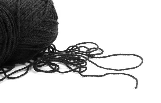 istock Black woolen threads. A skein of thread. Closeup. Isolated on a white background 1437677289