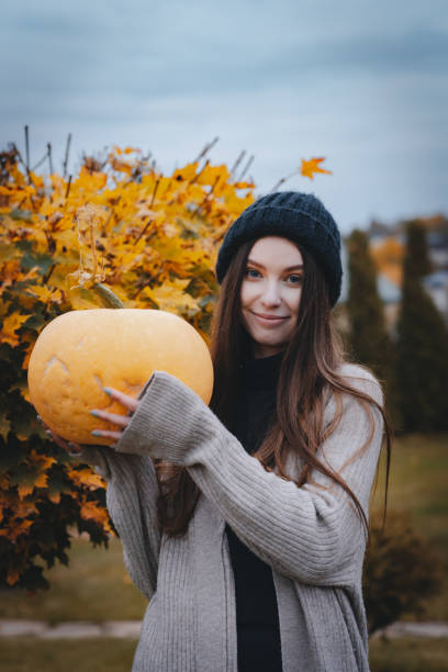 istock Girl with a pumpkin in her hands for Halloween. 1437677458