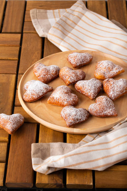 istock Heart shaped donuts on wooden table for Valentine's day 1437677665