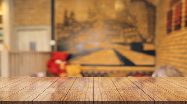 istock Empty wooden table top with lights bokeh on blur restaurant background. 1437678296