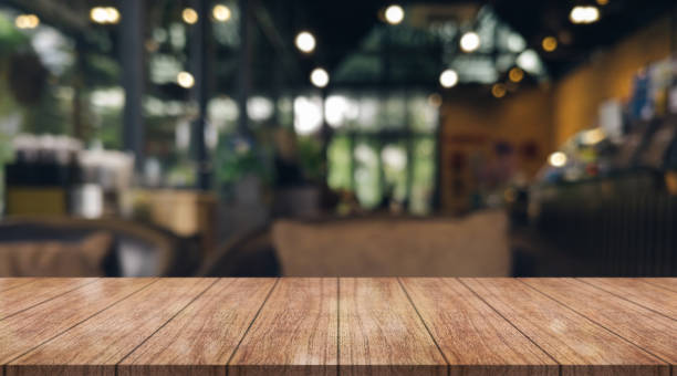 istock Empty wooden table top with lights bokeh on blur restaurant background. 1437678298