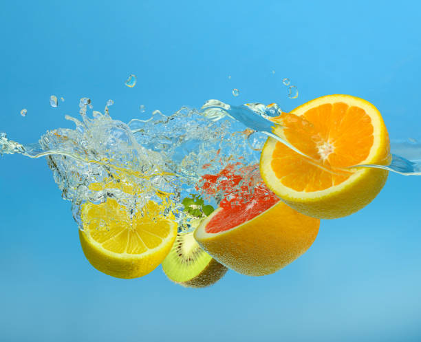 istock Fruits mix splashing into clear water on blue background 1437678997