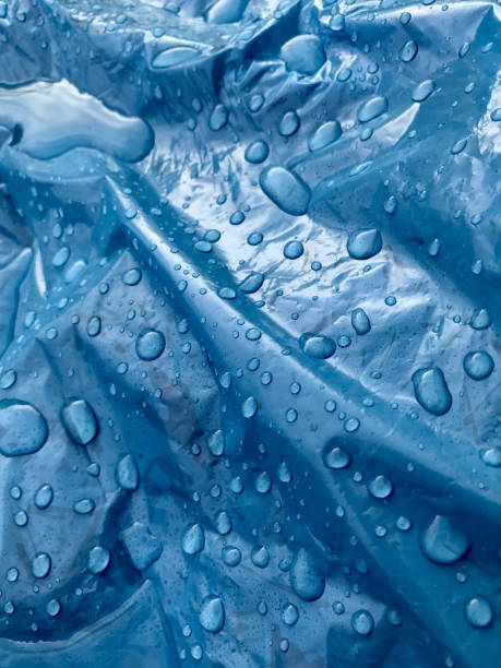 istock Closeup of the clean water droplets on a crumpled blue plastic surface 1437680320
