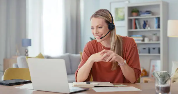 Photo of Consulting, communication and laptop with woman in home office for webinar, video call and online meeting with remote work. Contact, internet and technology with employee at desk for customer support