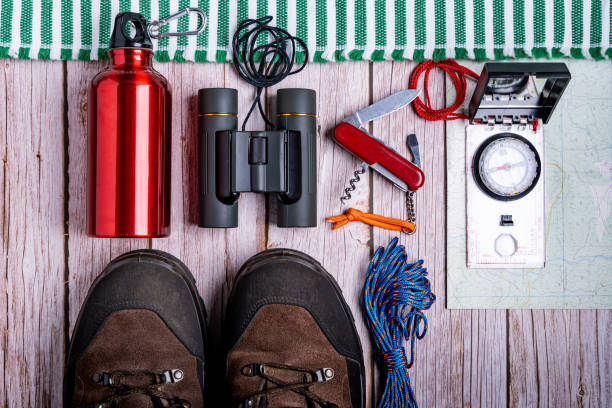 istock Flat lay of hiking equipment, essential tools on the wooden surface 1437682606