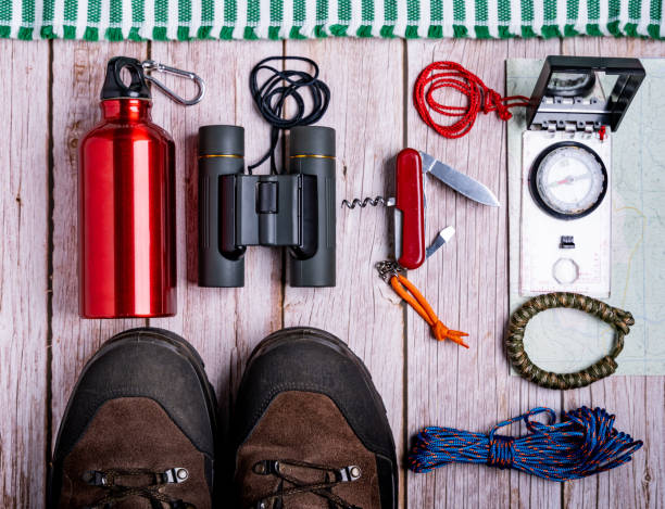 istock Flat lay of hiking equipment, essential tools on the wooden table 1437682607