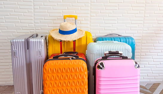 The colorful of travel suitcases in the airport terminal waiting area, summer vacation concept, traveling and enjoying concept