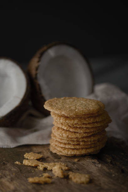 istock A stack of crunchy biscuits on a wooden board with half-cut coconut in the background 1437682723